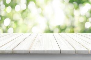 Blank white wooden surface with out-of-focus green bokeh photo