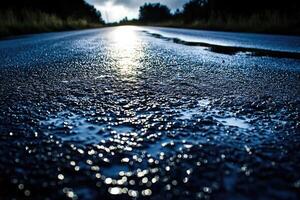 Wet asphalt road surface at dawn photo