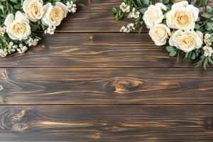 Cream roses and greenery on dark wood photo