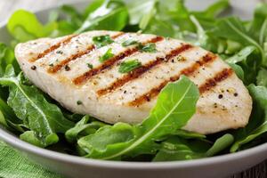 Grilled chicken breast with arugula salad photo