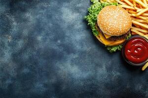 Hamburger and french fries on a dark background photo