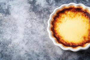 Small, individual custard tart. Golden, caramelized crust, creamy filling photo