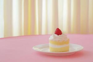 Delicate layered cake with a single strawberry photo