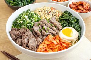 Flavorful Beef Noodle Bowl with Kimchi and Vegetables photo