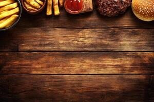 Burger, fries and ketchup on a wooden table photo