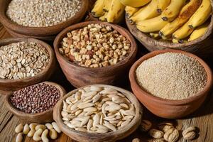 Assorted grains, nuts, and seeds in rustic bowls photo