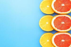 Citrus slices arranged vertically on a light blue background photo