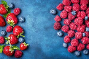 Fresh berries arranged on a deep blue surface photo