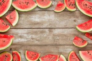 Watermelon slices arranged on a wooden surface photo