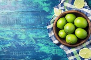 Fresh limes in a wooden bowl photo