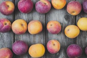 Fresh peaches arranged on weathered wood photo