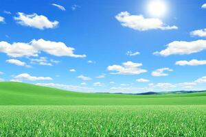 A green field with blue sky and clouds photo
