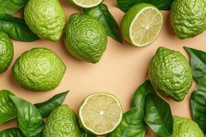 Fresh limes and leaves on a beige background photo