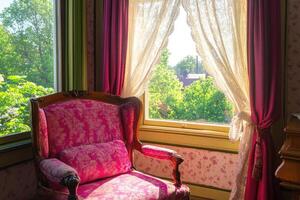 Vintage pink armchair by a sunlit window photo