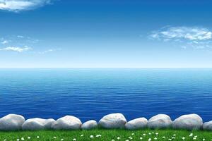 Tranquil coastal scene with a vast blue ocean and a grassy embankment lined with rocks under a clear sky photo