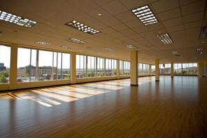 Empty, sunlit office space with expansive windows photo