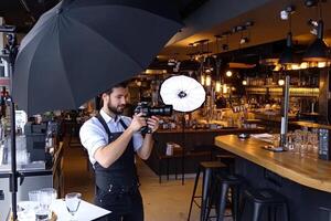 Professional photographer captures product shots inside a stylish bar photo