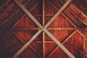 Wooden roof structure, intricate crisscrossing beams photo