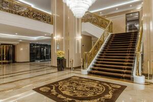 Luxurious hotel lobby with grand staircase photo