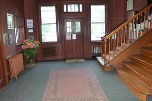 Historic interior hallway with stairs and windows photo