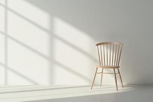 Simple, light-filled room with a wooden chair photo