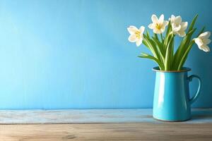 Fresh white tulips in a blue pitcher photo