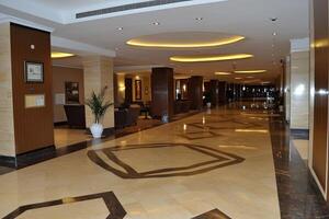 Elegant hotel hallway with polished floors and comfortable seating areas photo