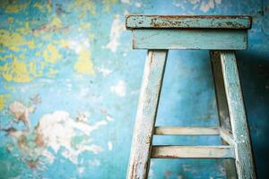 Vintage stool against a textured wall photo