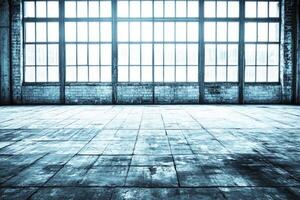 Empty industrial space with large windows photo