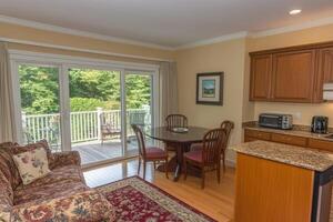 Bright, open-plan living area with patio access photo