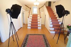 Elegant foyer with dual staircase, professional photography setup photo