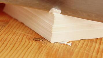 Relaxing ASMR paper cutting session with growing paper pile on wooden desk video