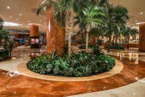 Luxurious hotel lobby with tropical landscaping photo