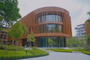 Modern building with wooden facade and lush landscaping photo