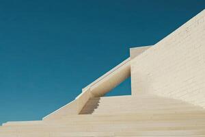 Modern, minimalist stairs against a vibrant blue sky photo