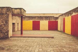 Empty courtyard, with muted colors and textured walls photo