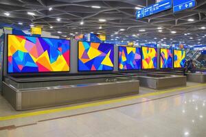 Colorful digital art displays in a modern train station. Large screens with vibrant geometric patterns photo