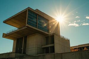 Modern concrete building bathed in sunlight photo