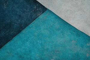 Textured concrete, teal and gray triangular shapes photo