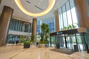 Modern, spacious lobby with ample natural light and greenery photo
