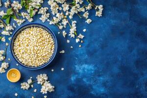 Small bowl of seeds, surrounded by spring blossoms photo