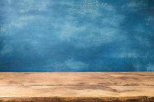 Wooden tabletop against a textured, deep blue wall photo