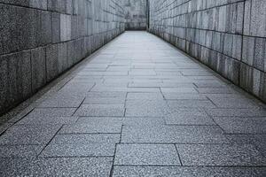 Gray stone pathway between walls photo