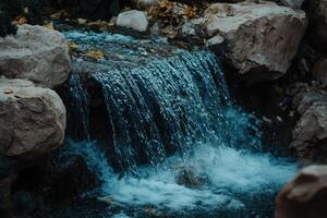 Cascading water over rocks in a small stream photo