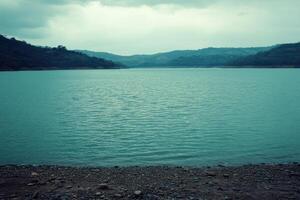 Calm reservoir reflecting a cloudy sky photo