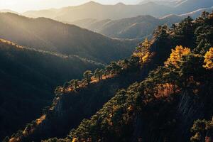 Autumnal mountain range bathed in golden light photo