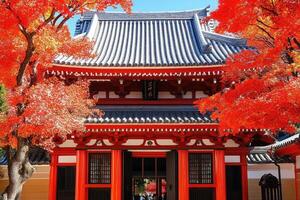 Autumnal Japanese temple facade. Vibrant fall foliage surrounds a traditional red and black building, with a distinctive, layered roof photo