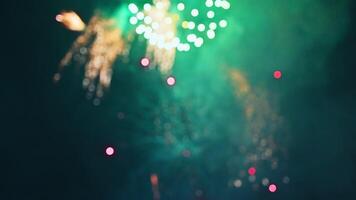 blurred colorful festive fireworks display at the celebration of pyrotechnic show on the background of night sky with multicolored bokeh video