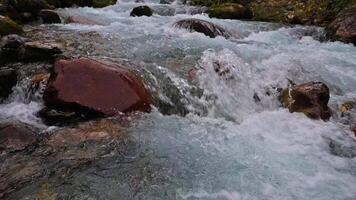 The slow flow of a mountain river, a stream flowing through the rocks. video