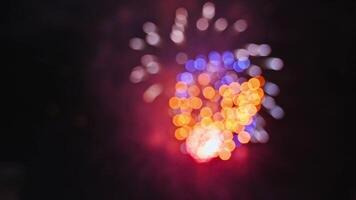 blurred colorful festive fireworks display at celebration of pyrotechnic show on background of night sky with color bokeh video